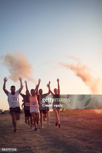 marathon racer werfen holi farben - holirun stock-fotos und bilder