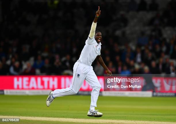 Jason Holder of the West Indies celebrates taking the wicket of Joe Root of England during day one of the 3rd Investec Test Match between England and...