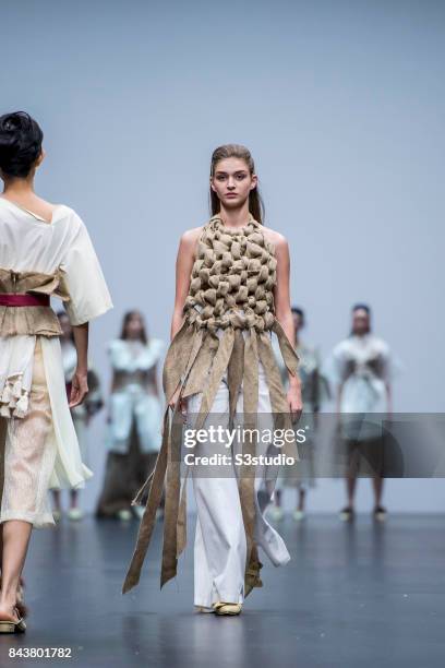 Model showcases designs by Sarah Devina Susanto on the runway during the Redress: The EcoChic Design Award 2017: Grand Final Fashion Show on the Day...