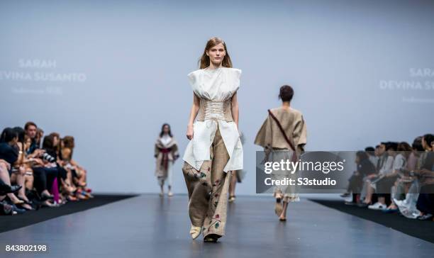 Model showcases designs by Sarah Devina Susanto on the runway during the Redress: The EcoChic Design Award 2017: Grand Final Fashion Show on the Day...