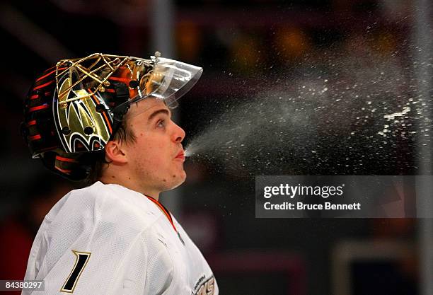 Jonas Hiller of the Anaheim Ducks spits out some water during his game against the New York Rangers on January 20, 2009 at Madison Square Garden in...