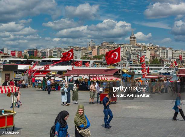 crowded eminonu square with turkish flags in istanbul,turkey - plaza eminonu fotografías e imágenes de stock