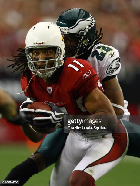 Wide receiver Larry Fitzgerald of the Arizona Cardinals attempts to break a tackle by cornerback Asante Samuel of the Philadelphia Eagles during the...