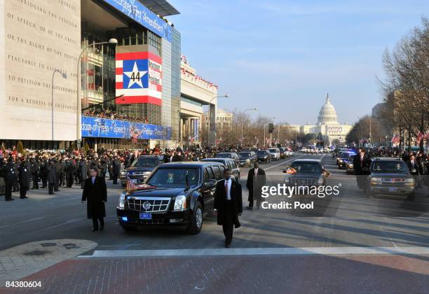 Limousine surrounded by four Secret Service agents carries President Barack Obama during the Inaugural Parade down Pennsylvania Avenue January 20,...