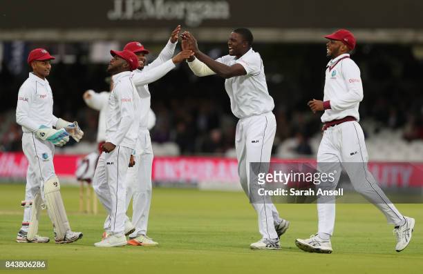 Jason Holder of West Indies celebrates with teammates after dismissing the England Captain Joe Root during day one of the 1st Investec Test match...