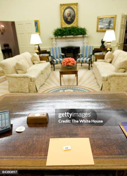 In this handout photo provided by the White House, a folder for U.S. President Barack Obama left by Former U.S. President George W. Bush sits on the...