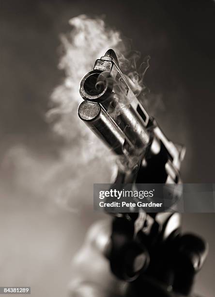 revolver with smoking barrel - fastest gun ストックフォトと画像