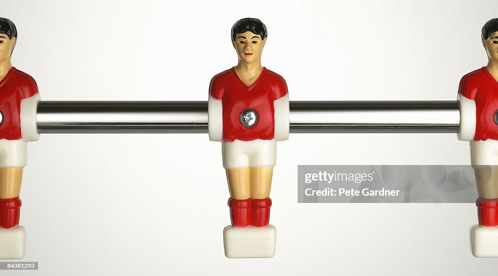 Table football player on chrome rod