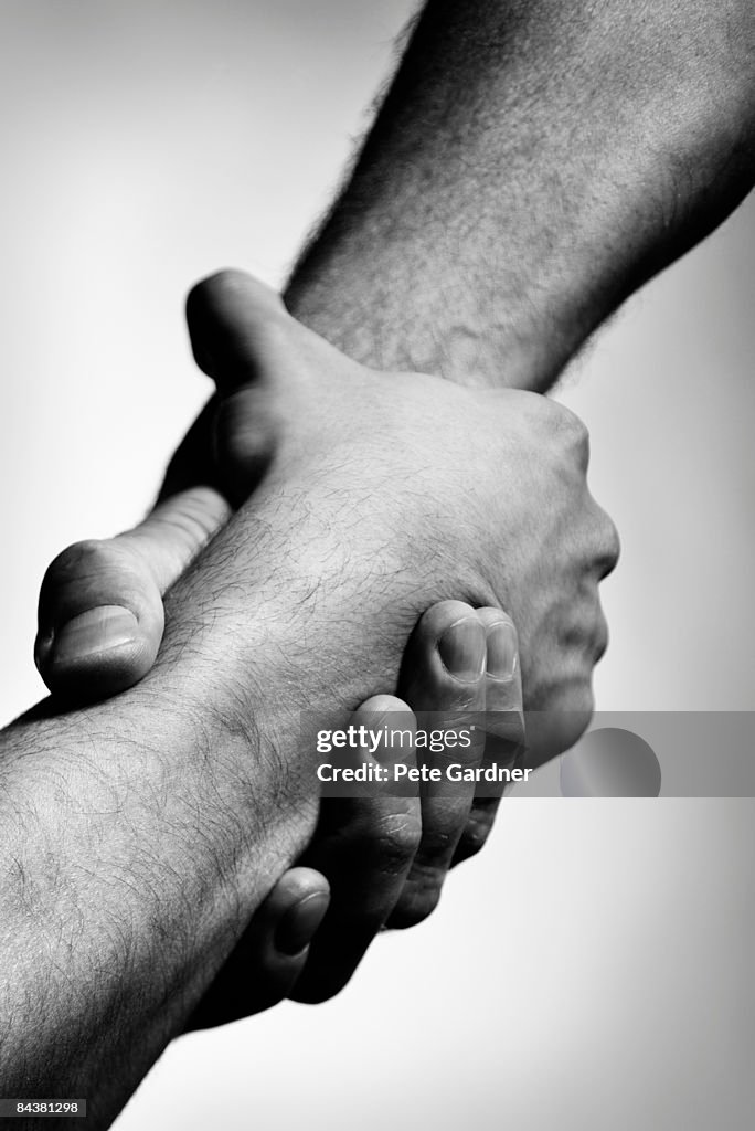 Two Interlocking Male Hands High-Res Stock Photo - Getty Images
