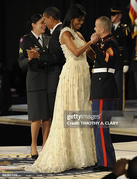 President Barack Obama dances with Army Sgt Margaret Herrera and his wife Michelle dances with Marine Sgt Eliidio Guillen during the Commander in...