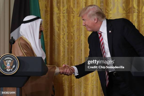 Amir Sabah Al-Ahmad Al-Jaber Al-Sabah of Kuwait and U.S. President Donald Trump shake hands during a joint news conference in the East Room of the...
