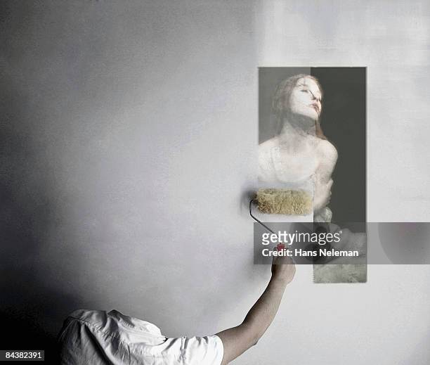 invisible man erasing an image from the wall - invisible man stock-fotos und bilder