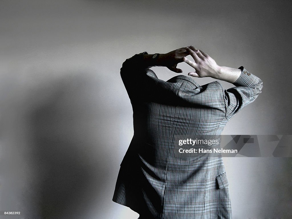 Invisible man holding his head