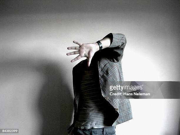 invisible man blocking his invisible face - invisible man fotografías e imágenes de stock
