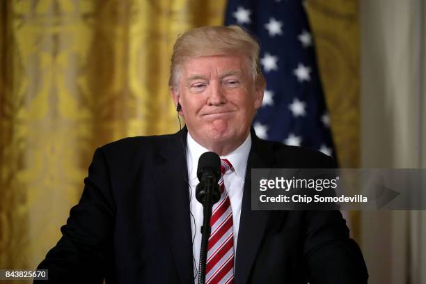 President Donald Trump answers reporters' questions during a joint news conference with Amir Sabah Al-Ahmad Al-Jaber Al-Sabah of Kuwait in the East...