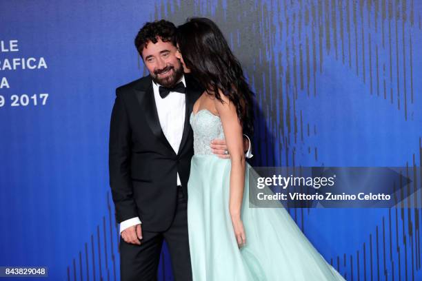 Giglia Marra and Federico Zampaglione walk the red carpet ahead of the 'Manuel' screening during the 74th Venice Film Festival at Sala Giardino on...