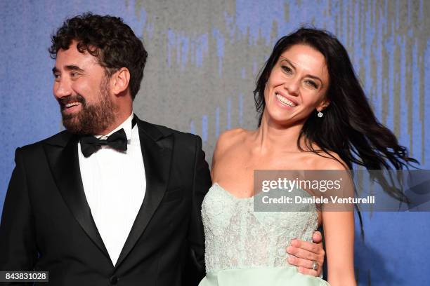 Giglia Marra and Federico Zampaglione walk the red carpet ahead of the 'Manuel' screening during the 74th Venice Film Festival at Sala Giardino on...