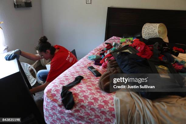 Jamie Praslicka cleans out a damaged piece of furniture in her flooded home on September 7, 2017 in Richwood, Texas. Over a week after Hurricane...