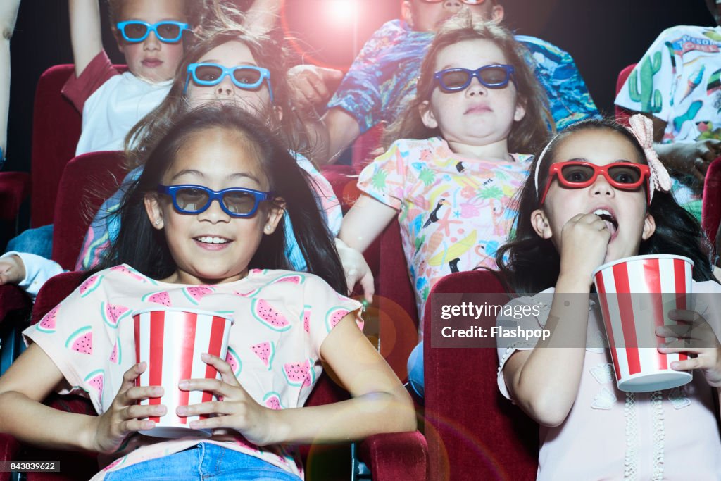 Group of children enjoying a movie at the cinema