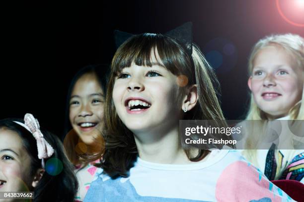 portrait of girl watching a movie at the cinema - get out 2017 film stock-fotos und bilder