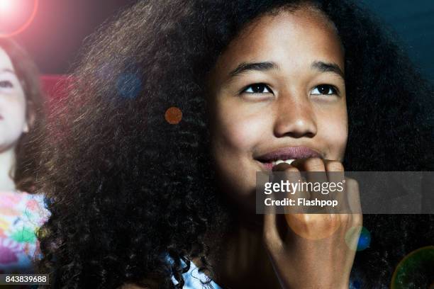 portrait of girl watching a movie at the cinema - get out film 2017 stock pictures, royalty-free photos & images