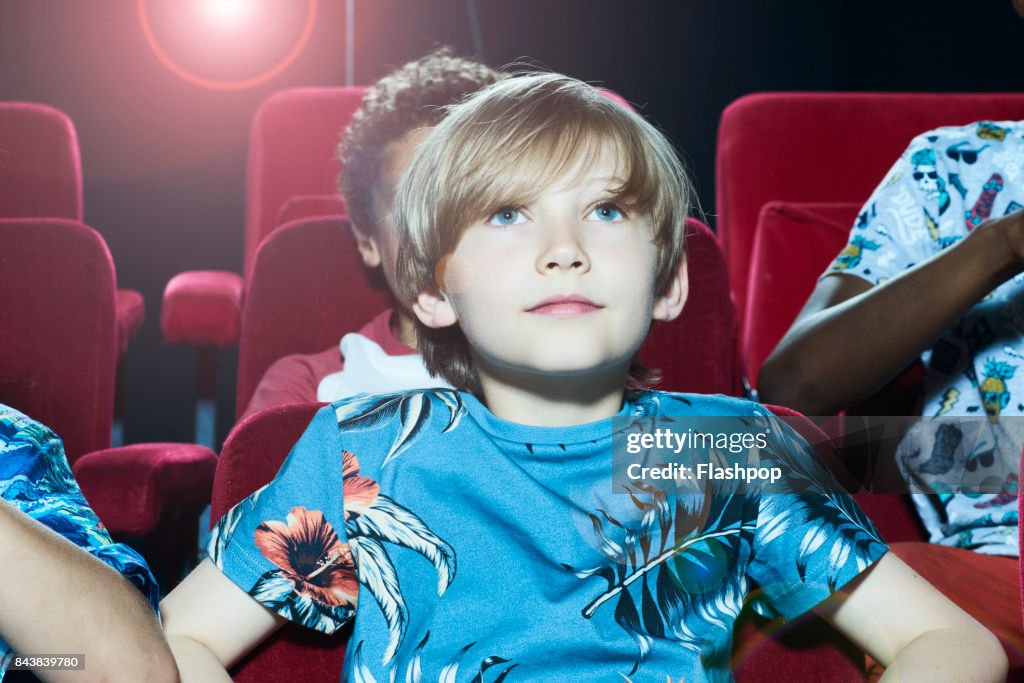 Portrait of boy watching a movie at the cinema