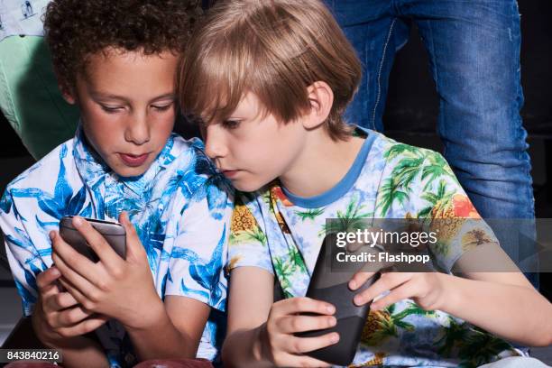 group of friends using their phones - child on phone stock pictures, royalty-free photos & images