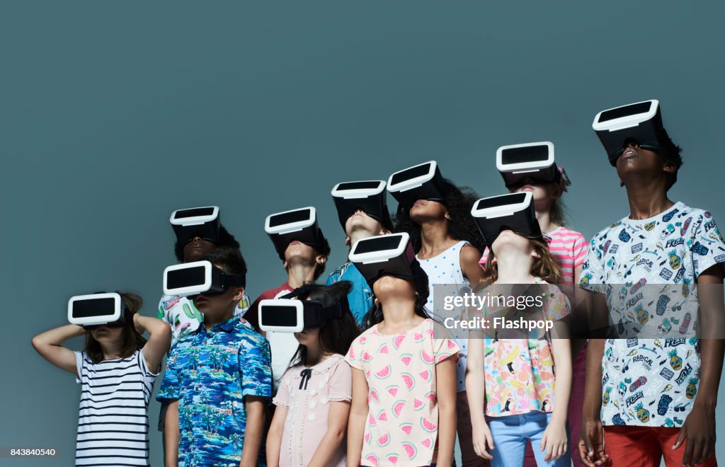 Group of children wearing virtual reality headsets