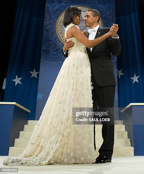 President Barack Obama and First Lady Michelle Obama dance during the Southern Regional Inaugural Ball at the DC Armory in Washington, DC, early...