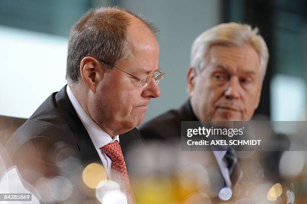 German Economic Minister Michael Glos and Finance Minister Peer Steinbrueck wait for the beginning of a cabinet's meeting on January 21, 2009 in...