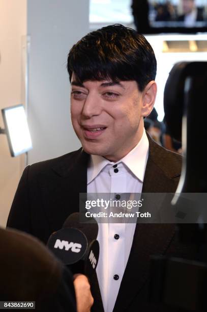 Designer Malan Breton speaks backstage during the Malan Breton fashion show during New York Fashion Week at Intrepid on September 7, 2017 in New York...