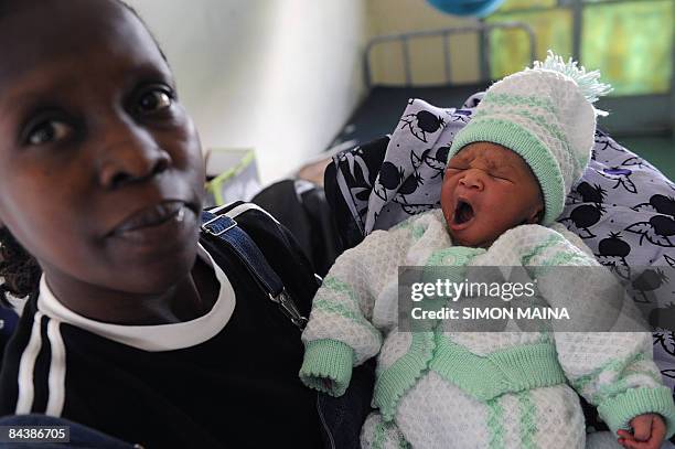 This picture taken on January 21, 2009 shows a Kenyan baby Michelle Obama, named after US new First Lady, in the arms of his mother Linda Omondi,...