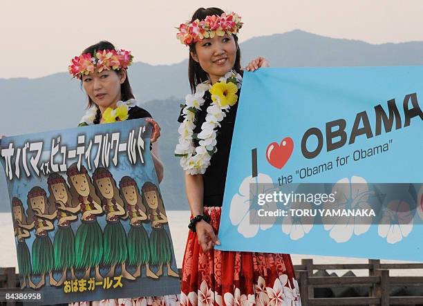 Housewives hold banners to introduce their group of hula "Obama Girls" during a rally to support US Democratic presidential hopeful Sen. Barack Obama...