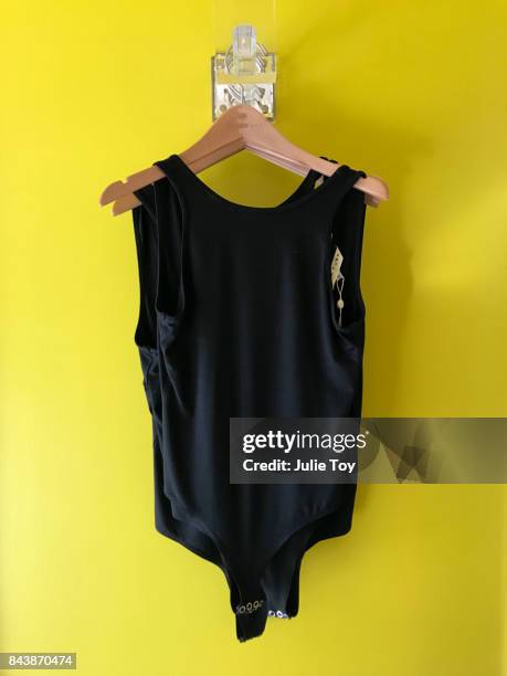 black leotard on yellow wall - gympak stockfoto's en -beelden