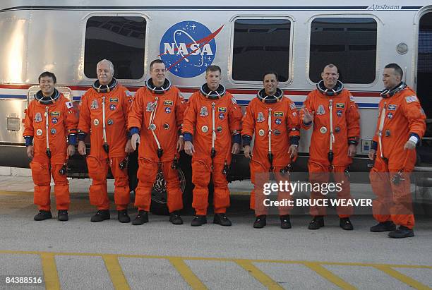 The US space Shuttle Discovery's crew pose on January 21, 2009 as they leave the crew quarters at Kennedy Space Center in Florida for a ride to...