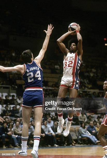 S: Julius Eving of the New Jersey Nets shoots over Bobby Jones of the Philadelphia 76ers during a mid circa 1970's NBA basketball game at the Rutgers...