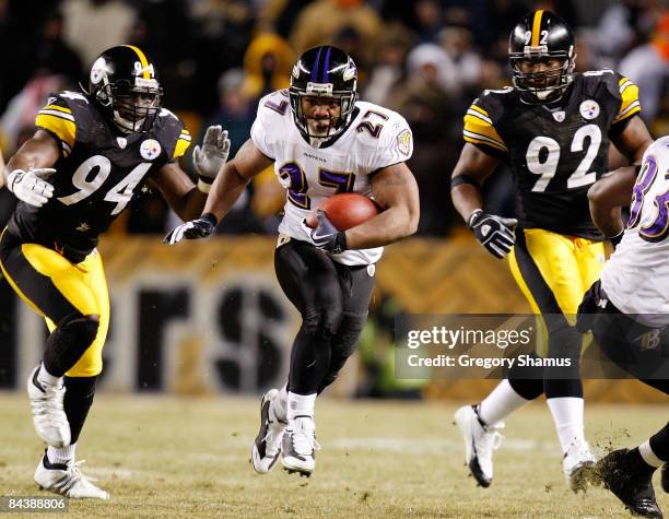 Running back Ray Rice of the Baltimore Ravens runs the ball against linebacker linebackers Lawrence Timmons and James Harrison of the Pittsburgh...