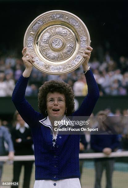 Billie Jean King of the USA holds up the championship trophy for women's singles of the Wimbledon Lawn Tennis Championships after defeating Evonne...