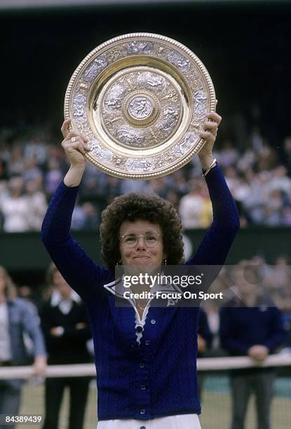 Billie Jean King of the USA holds up the championship trophy for women's singles of the Wimbledon Lawn Tennis Championships after defeating Evonne...