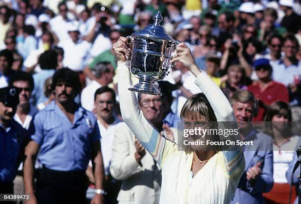Tennis player Chris Evert Lloyd of the USA hold the trophy above her head after defeating Hana Mandlikova 5-7,6-1,6-1 during the women finals of the...