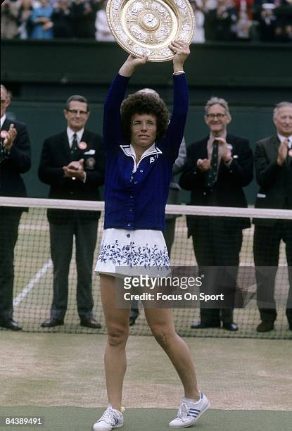 Billie Jean King of the USA holds up the championship trophy for women's singles of the Wimbledon Lawn Tennis Championships after defeating Evonne...