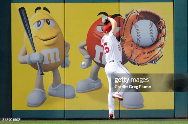 Adam Lind of the Washington Nationals tries to catch a double by Odubel Herrera of the Philadelphia Phillies in the third inning at Nationals Park on...