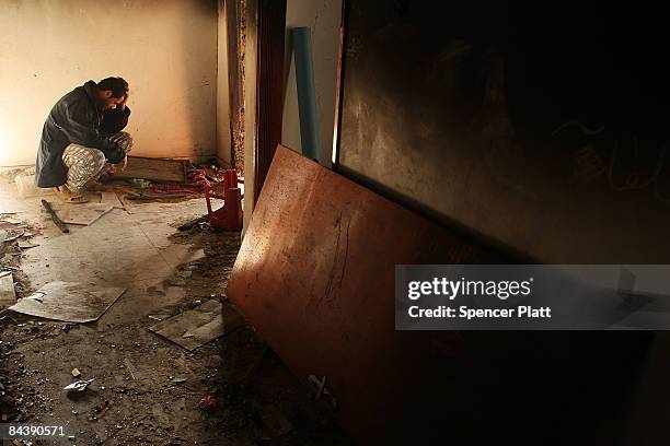 Man sits in his destroyed home January 21, 2009 in a suburb of Gaza City, Gaza Strip. Over 70 percent of Gaza is still without power with chronic...