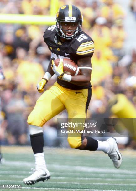 Running back Akrum Wadley of the Iowa Hawkeyes rushes up field during the fourth quarter against the Wyoming Cowboys on September 2, 2017 at Kinnick...