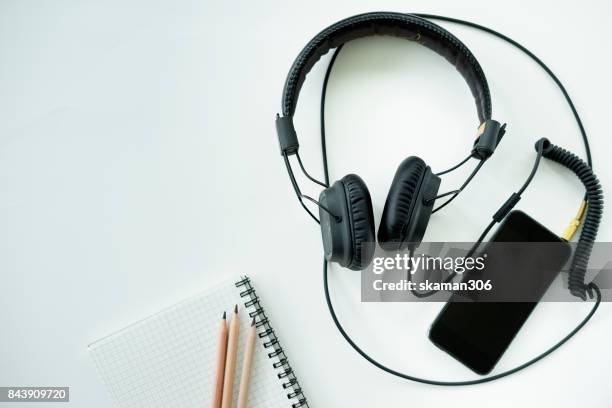 top view office working desk with headphone notepad and tablet ,keyboard and sunglasses relaxing drink with coffee cup and roasted coffee seed - coffee drink on white stock pictures, royalty-free photos & images