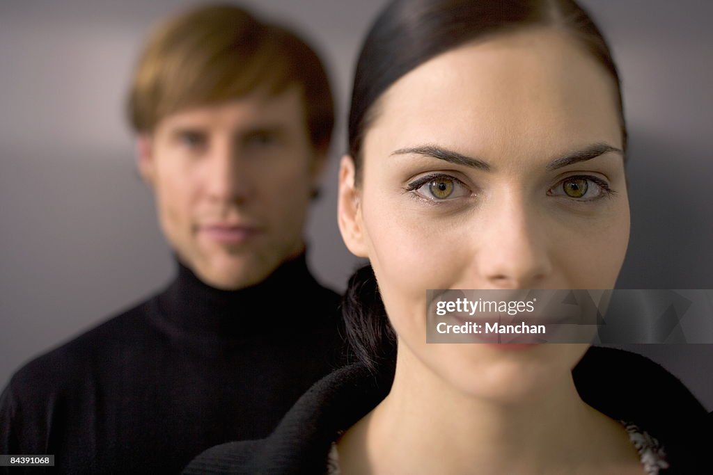 Two young executives looking into camera, smiling