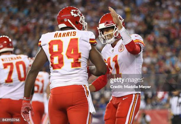 Demetrius Harris and Alex Smith of the Kansas City Chiefs celebrate scoring a touchdown during the first quarter against the New England Patriots at...