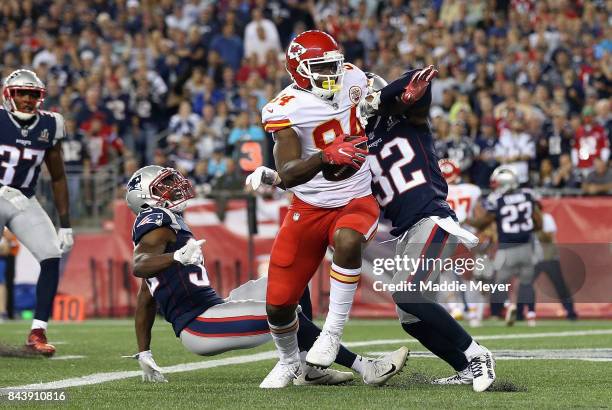 Demetrius Harris of the Kansas City Chiefs makes a touchdown reception during the first quarter against Duron Harmon and Devin McCourty of the New...