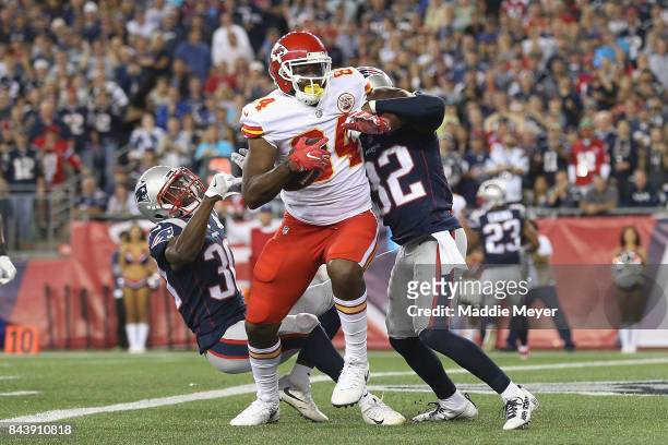 Demetrius Harris of the Kansas City Chiefs makes a touchdown reception during the first quarter against Duron Harmon and Devin McCourty of the New...