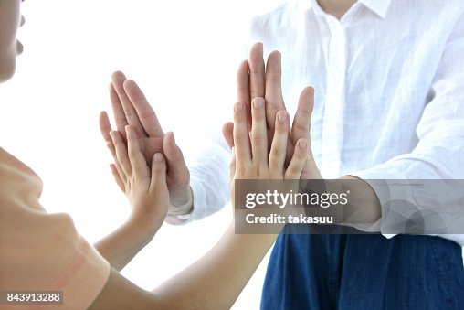 High five between son and mom High five between son and mom